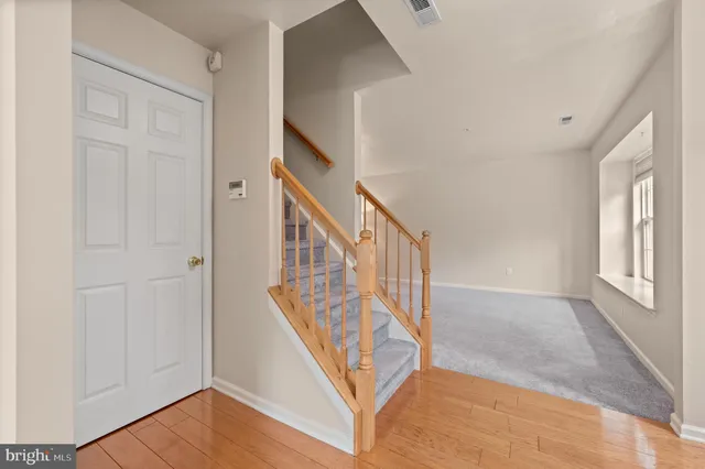 a view of an entryway with wooden floor
