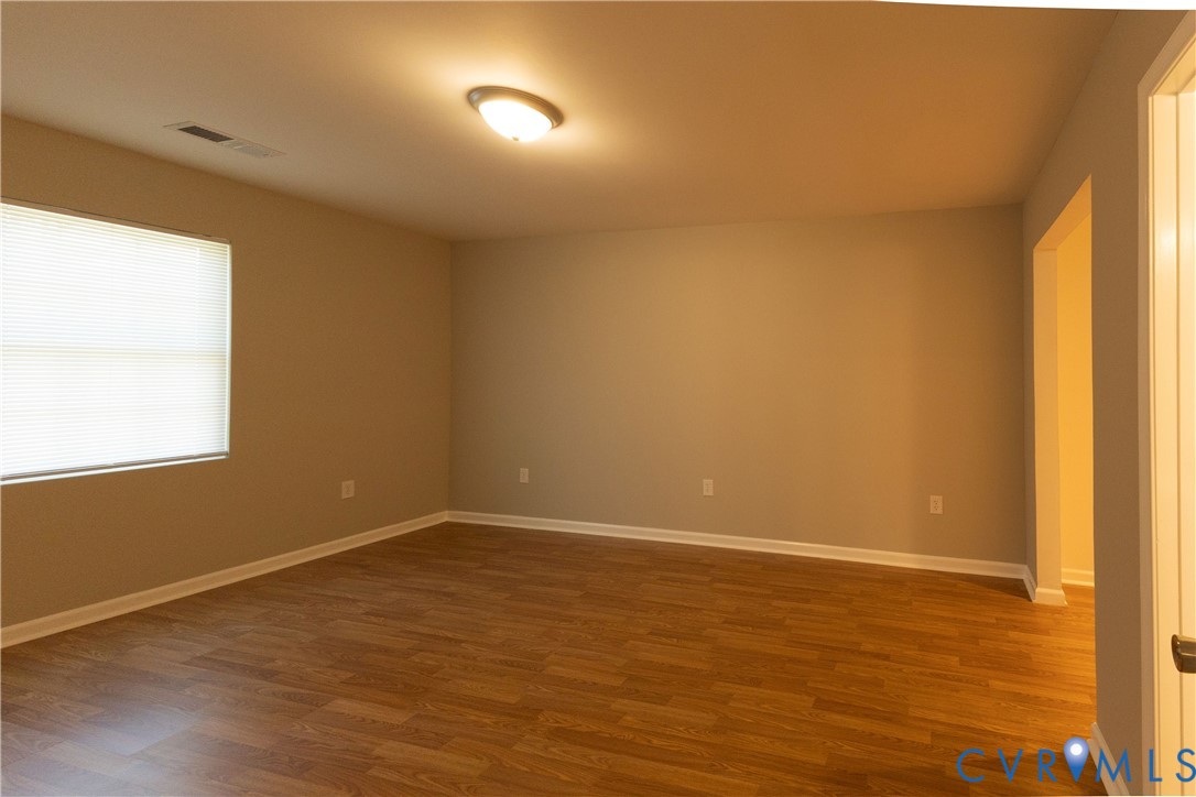 398 Blinkys Road New Canton, VA 23123 - Photo 16 of 21 an empty room with wooden floor and windows