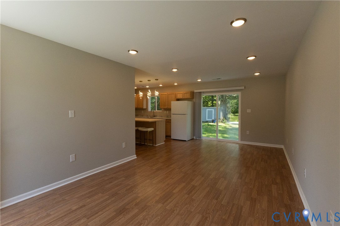 398 Blinkys Road New Canton, VA 23123 - Photo 5 of 21 a view of a big room with wooden floor and windows