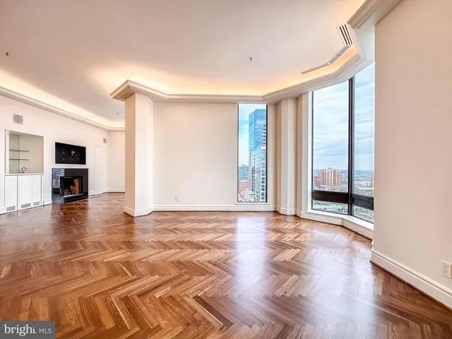 a view of empty room with wooden floor