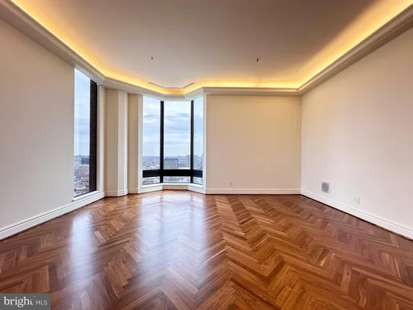 a living room with furniture and a large mirror