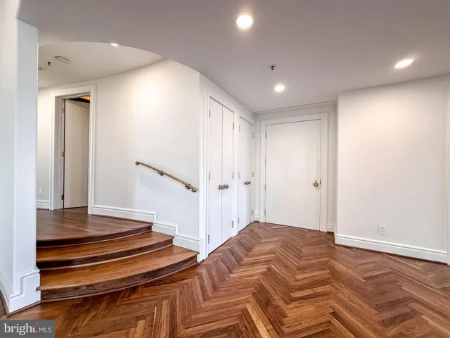 a view of a room with wooden floor and window