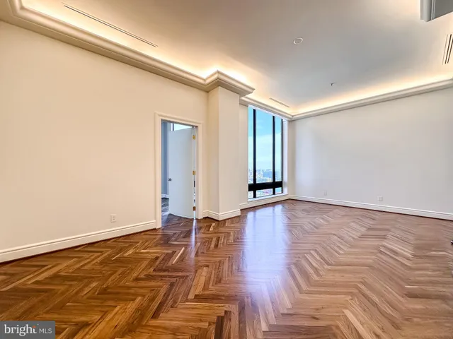 a living room with furniture gym equipment and a rug