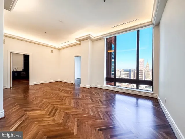 a living room with furniture and floor to ceiling window