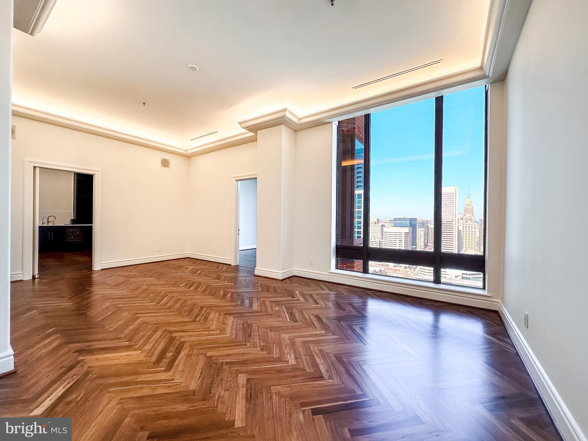 10 East Lee Street, Unit 2701 Baltimore, MD 21202 - Photo 27 of 58 a view of a room with wooden floor and window
