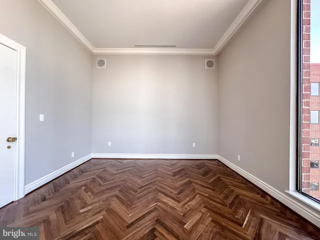 a living room with furniture and large windows