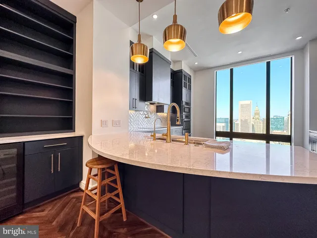a kitchen with stainless steel appliances kitchen island granite countertop wood cabinets and granite counter tops