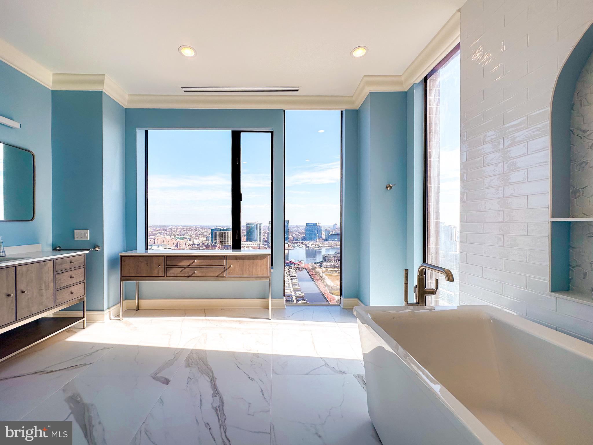 10 East Lee Street, Unit 2701 Baltimore, MD 21202 - Photo 36 of 58 a spacious bathroom with a large tub and large window