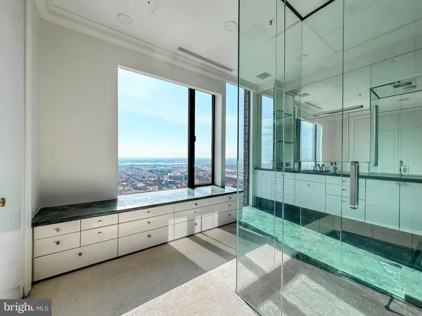 a bathroom with a sink a toilet a mirror and shower