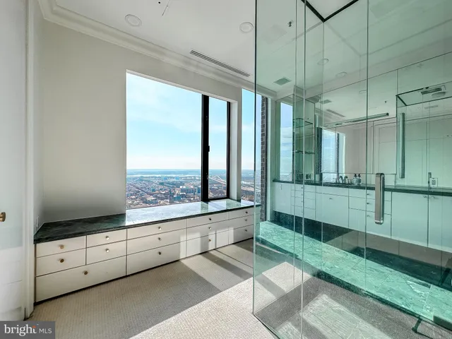 a bathroom with a sink a toilet a mirror and shower