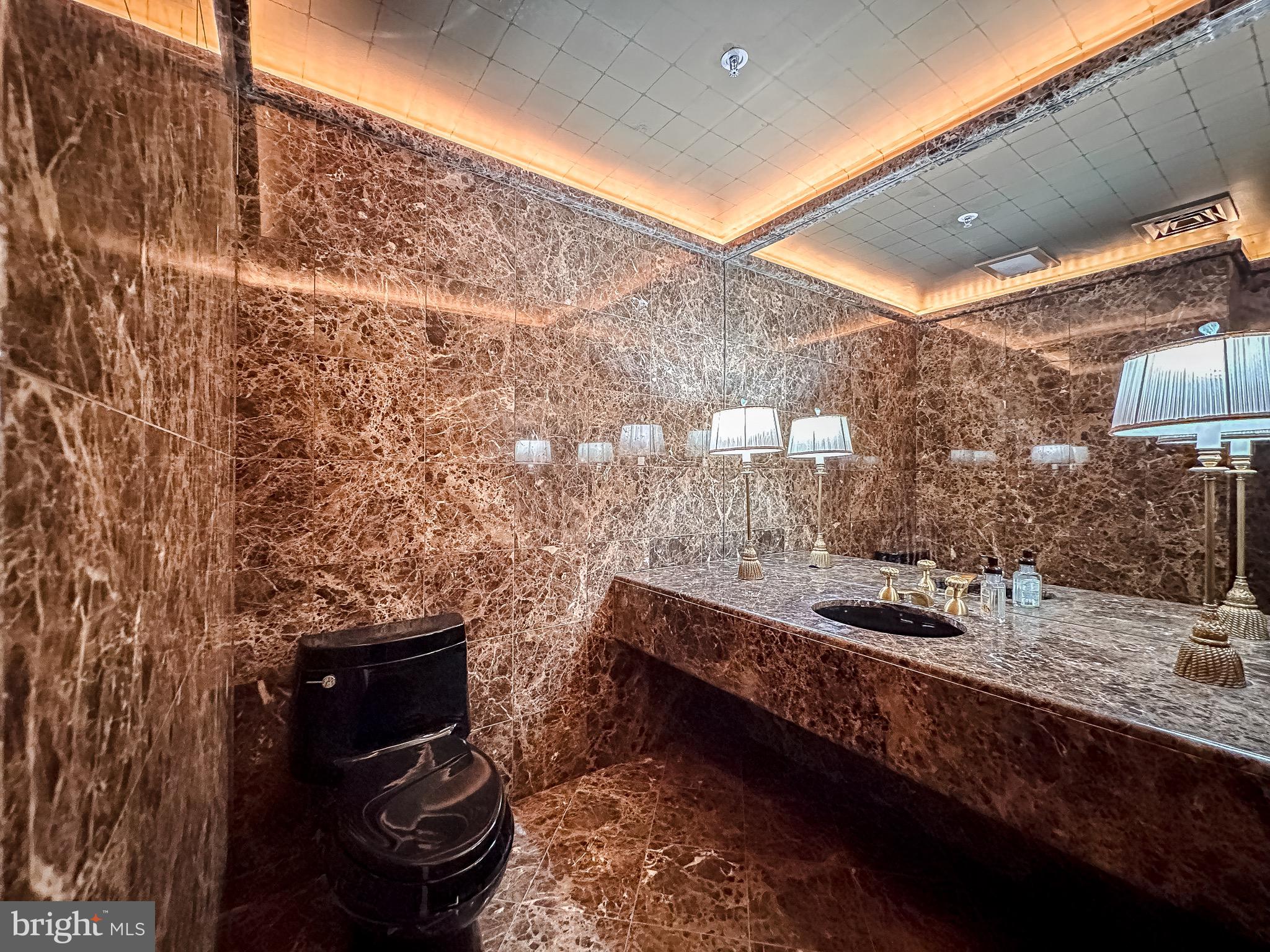 10 East Lee Street, Unit 2701 Baltimore, MD 21202 - Photo 43 of 58 a bathroom with a sink and a mirror