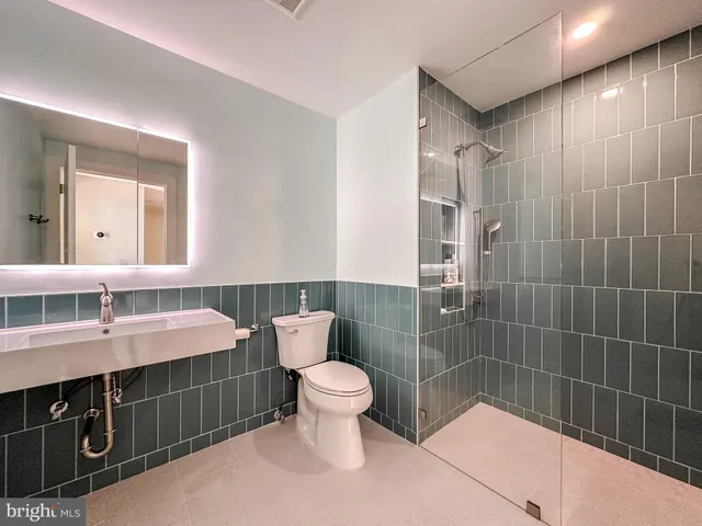 a view of a terrace with lawn chairs