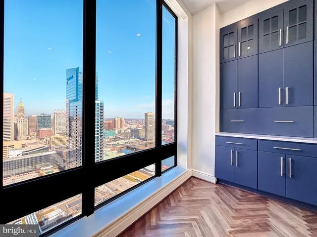 a kitchen with kitchen island a sink and a stove with wooden cabinets