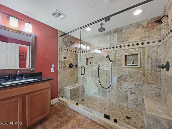 a bathroom with a shower sink and mirror