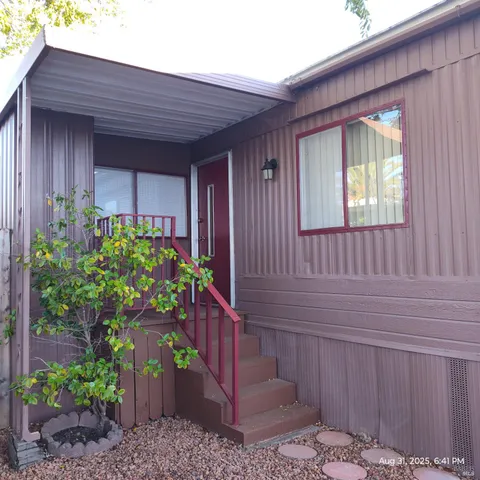 a view of a house with a backyard