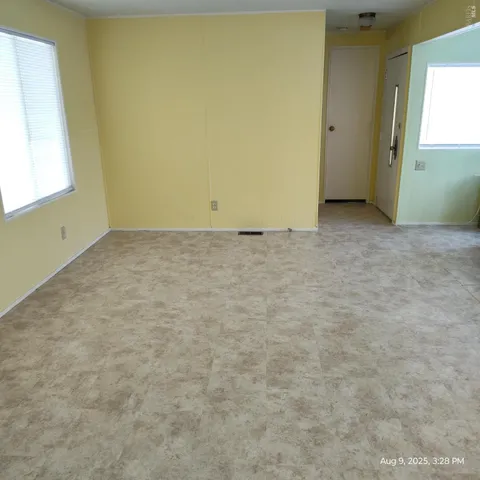 a living room with a couch and potted plant