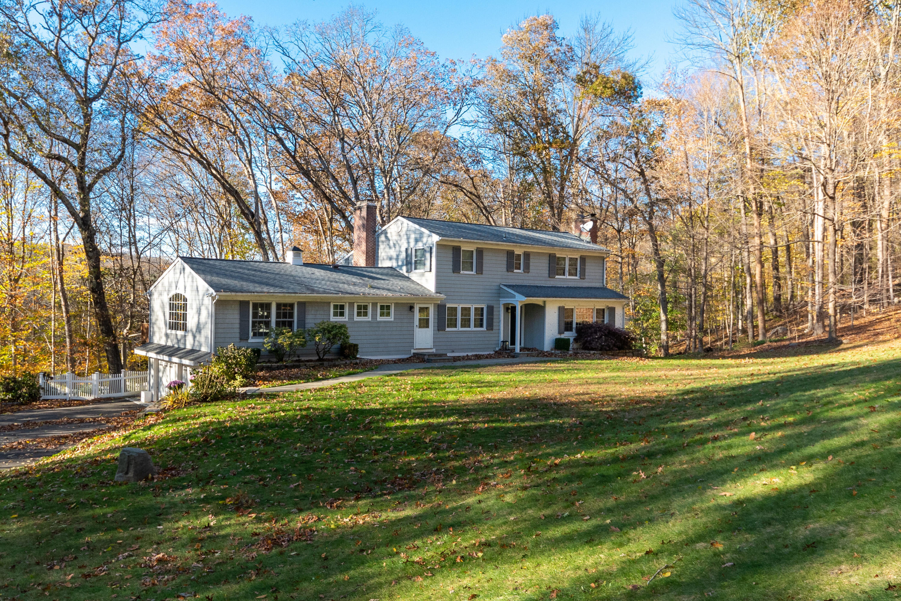 32 Colonial Road New Canaan, CT 06840 - Photo 19 of 22 a view of a big house with a big yard and large trees