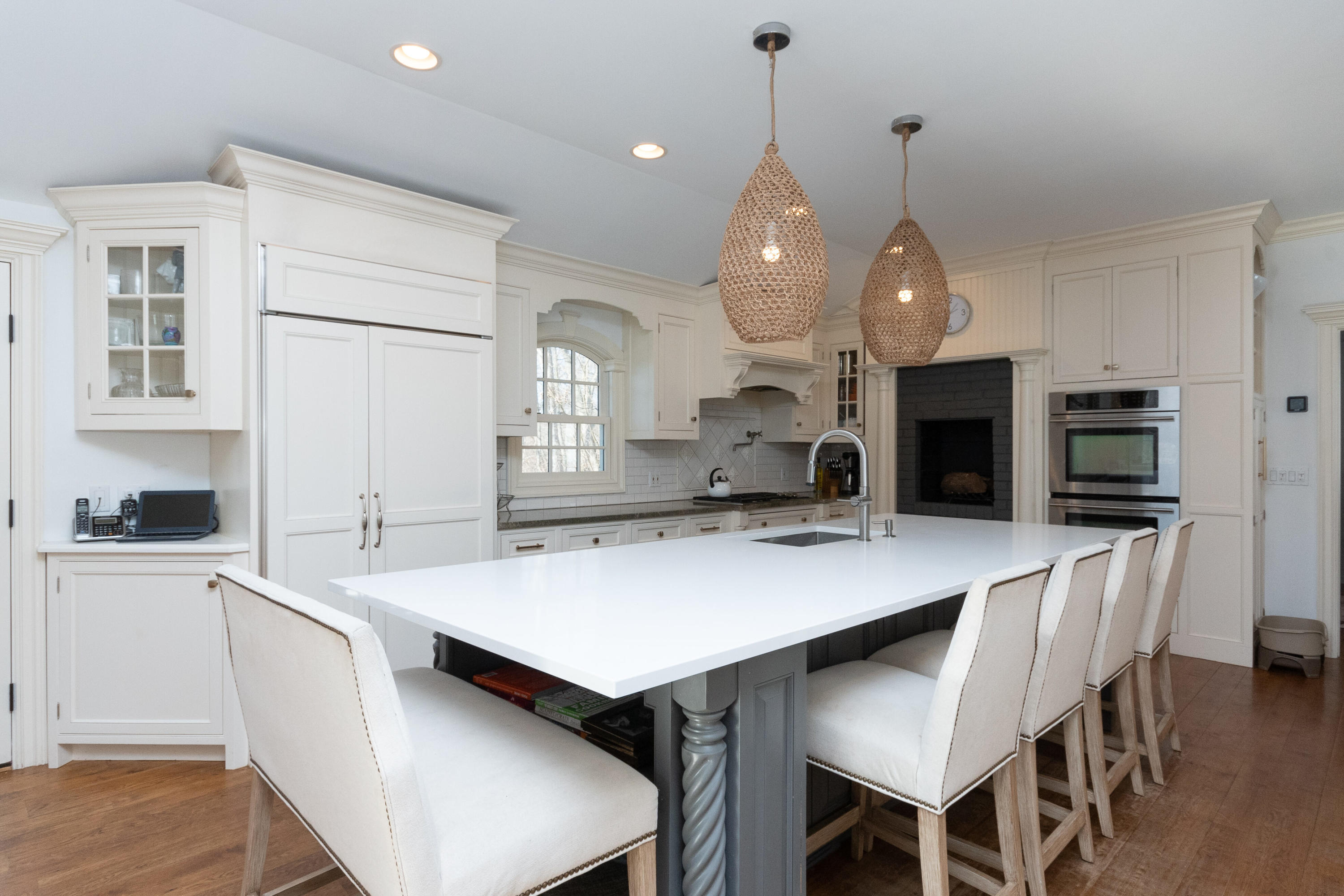 32 Colonial Road New Canaan, CT 06840 - Photo 7 of 22 a kitchen with a dining table chairs and white cabinets
