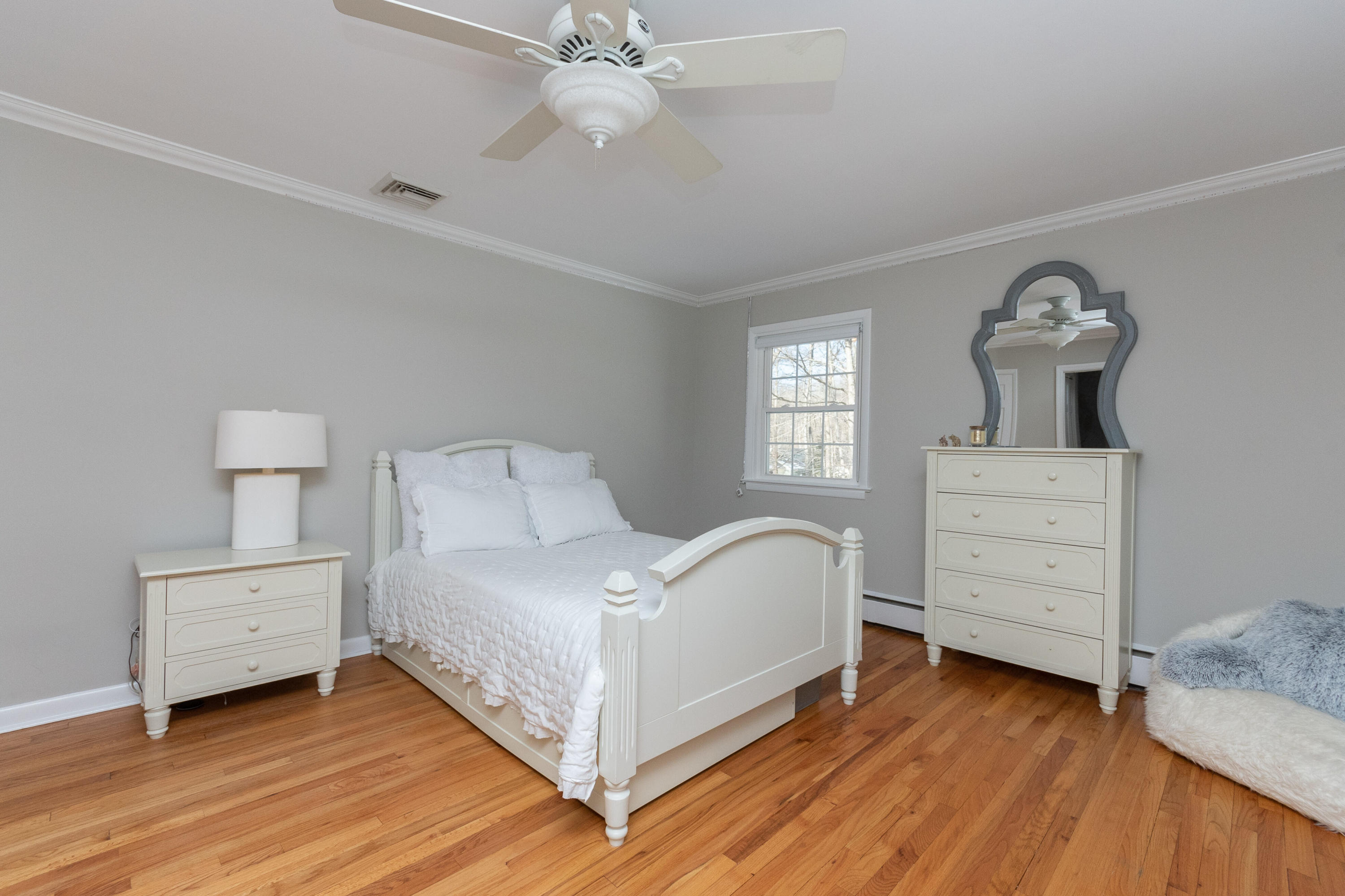 32 Colonial Road New Canaan, CT 06840 - Photo 10 of 22 a bedroom with a bed and a dresser