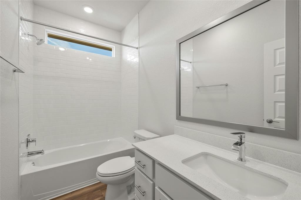 113 Shadow Oak Cove Georgetown, TX 78628 - Photo 29 of 40 A well-lit primary bathroom featuring a clean, modern vanity and a bright window above the tub.
