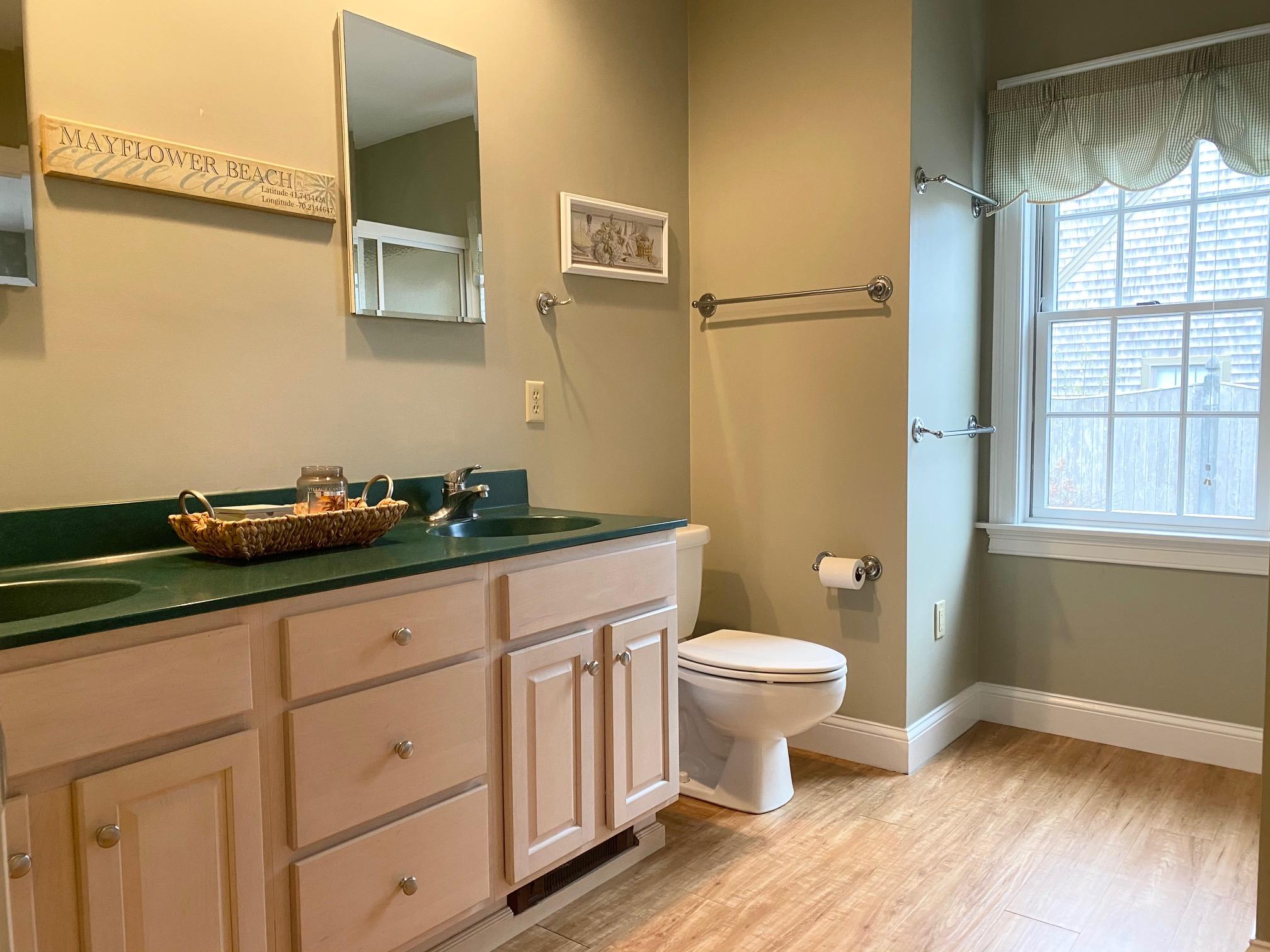 37 Horsefoot Path Dennis, MA 02638 - Photo 14 of 50 a bathroom with a granite countertop sink a toilet and a window
