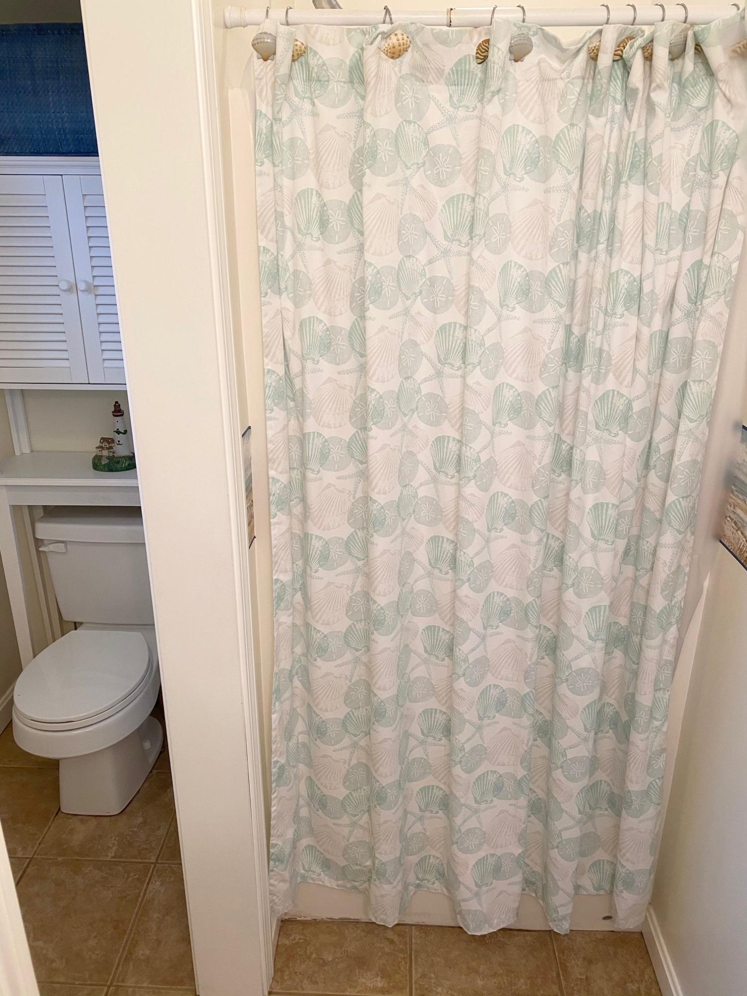 37 Horsefoot Path Dennis, MA 02638 - Photo 37 of 50 a bathroom with a toilet and a shower curtain