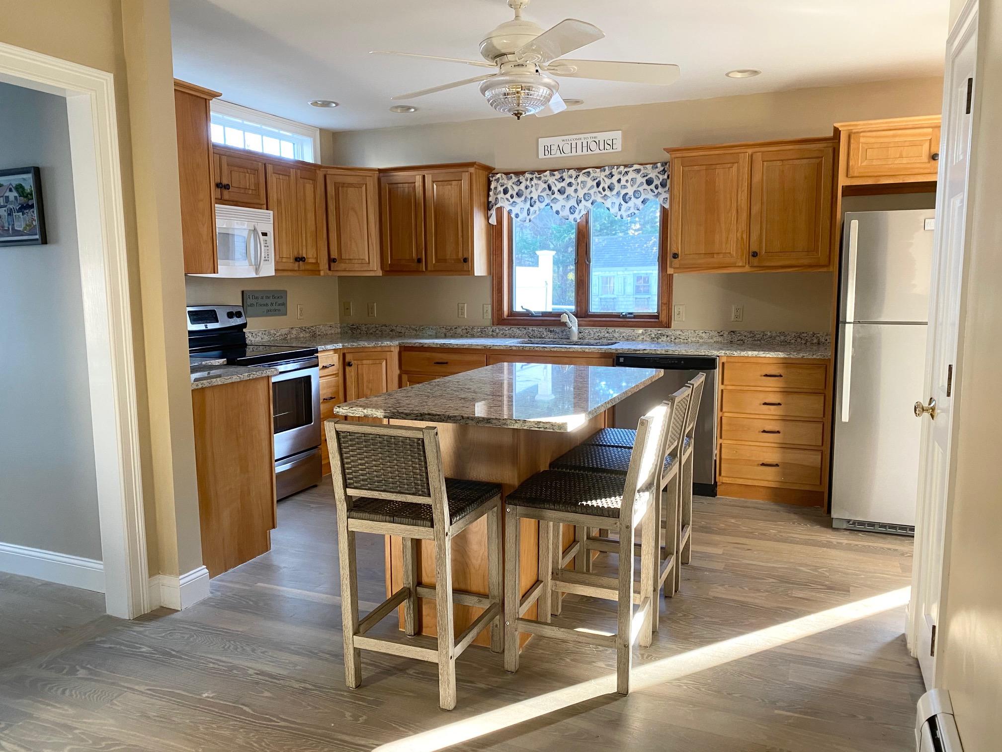 37 Horsefoot Path Dennis, MA 02638 - Photo 10 of 50 a kitchen with kitchen island granite countertop wooden floors cabinets and stainless steel appliances
