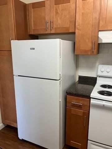 763 Main Street, Unit 44 Waltham, MA 02451 - Photo 7 of 11 a white refrigerator freezer and a stove sitting inside of a kitchen