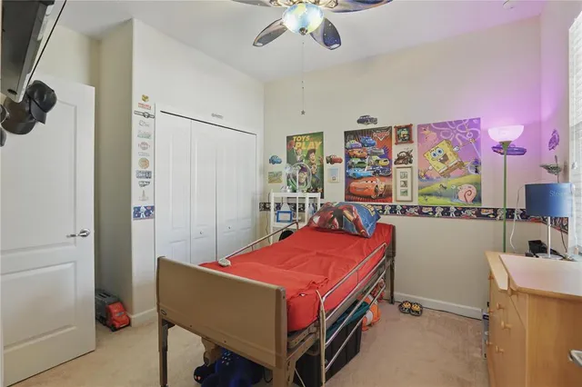 a room with pool table and paintings on the wall