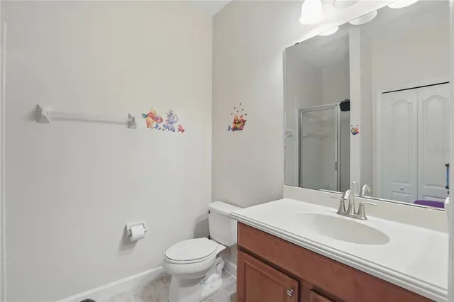 a bathroom with a sink vanity mirror and toilet