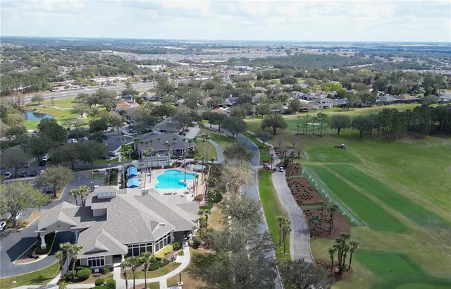 an aerial view of a house with outdoor space and lake view