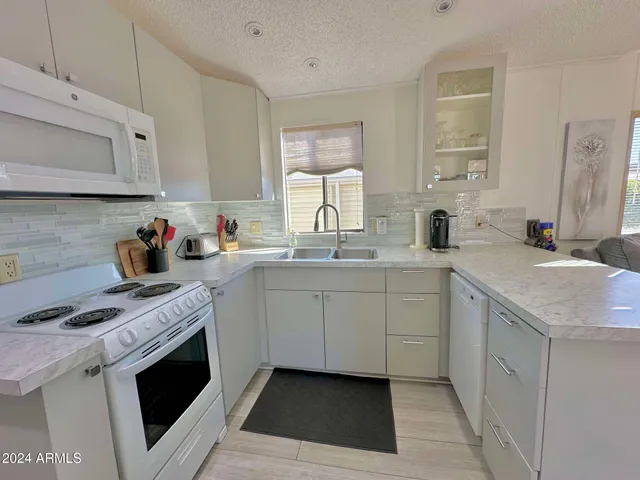 a living room with furniture a table and chairs