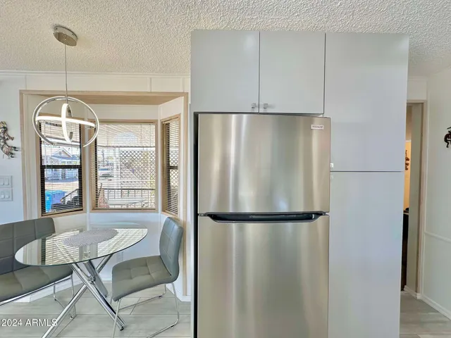 a kitchen with granite countertop a sink stainless steel appliances and cabinets