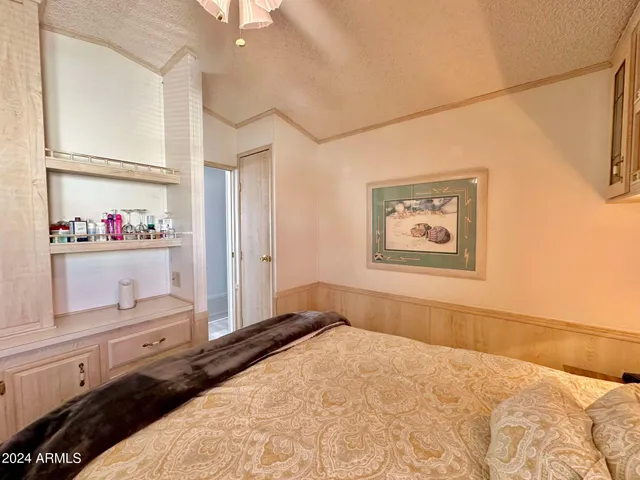 a bedroom with a bed wooden floor and window