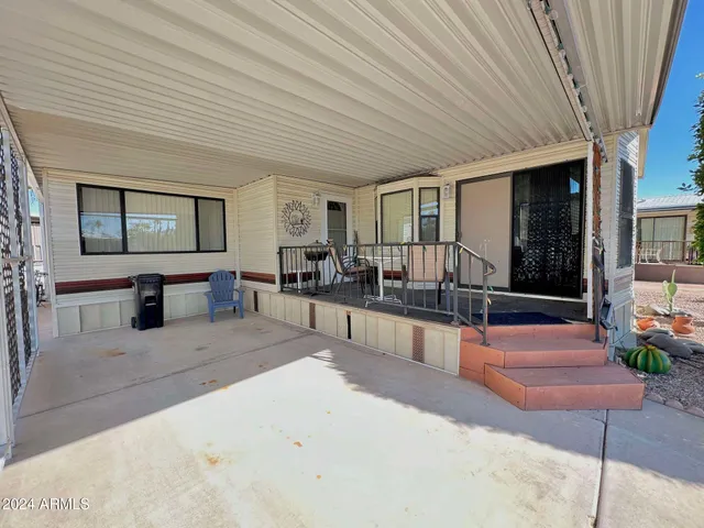 a view of a chairs and table in patio