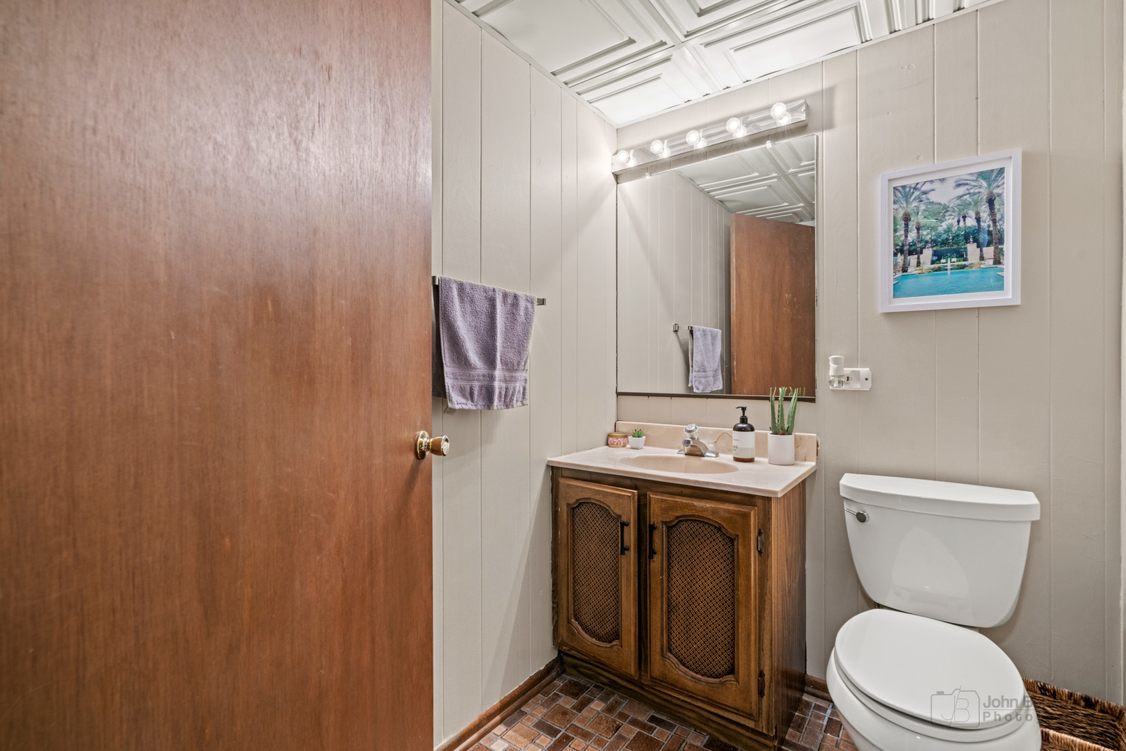 1223 Itasca Road Addison, IL 60101 - Photo 36 of 42 a bathroom with a toilet a sink and mirror