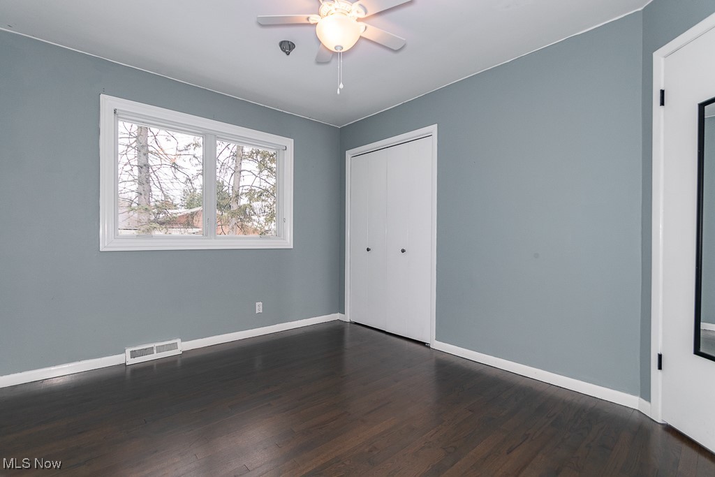 38856 Johnnycake Ridge Road Willoughby, OH 44094 - Photo 12 of 49 Bedroom featuring ceiling fan, dark hardwood flooring, and a closet