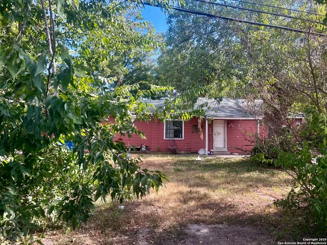 a view of a house with a tree in the yard
