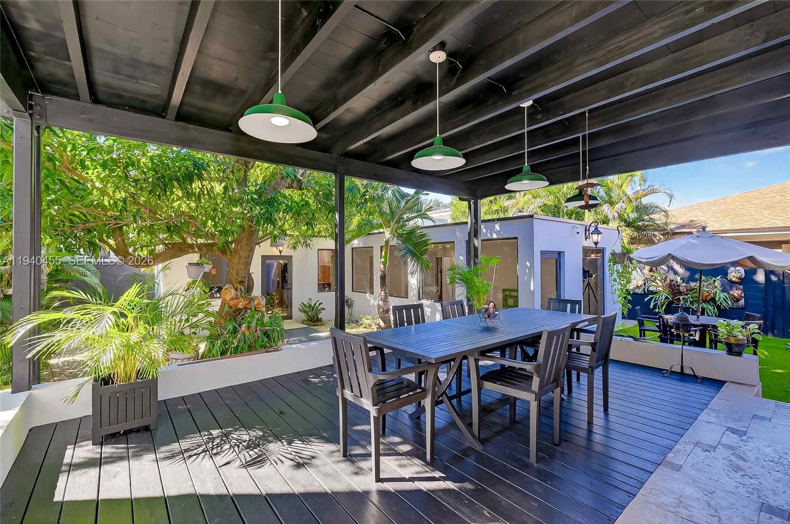452 Southwest 21st Road Miami, FL 33129 - Photo 30 of 51 a view of a table and chairs in patio with wooden fence