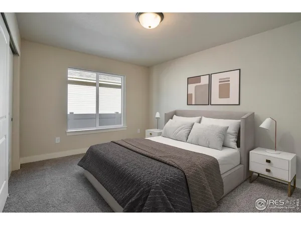 a bedroom with a white bed and a window