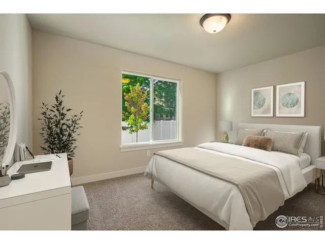 a bedroom with a bed and a white wall