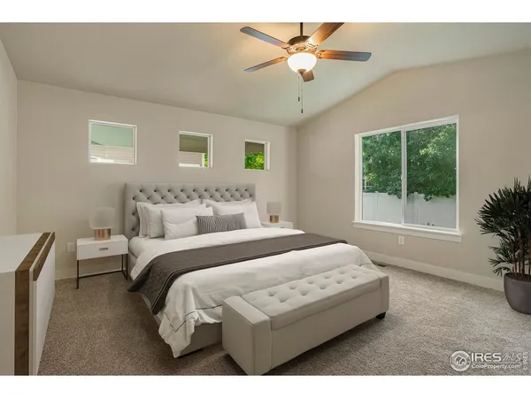 a bedroom with a large bed and a chandelier