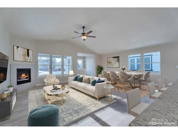 a living room with furniture two window and a fireplace