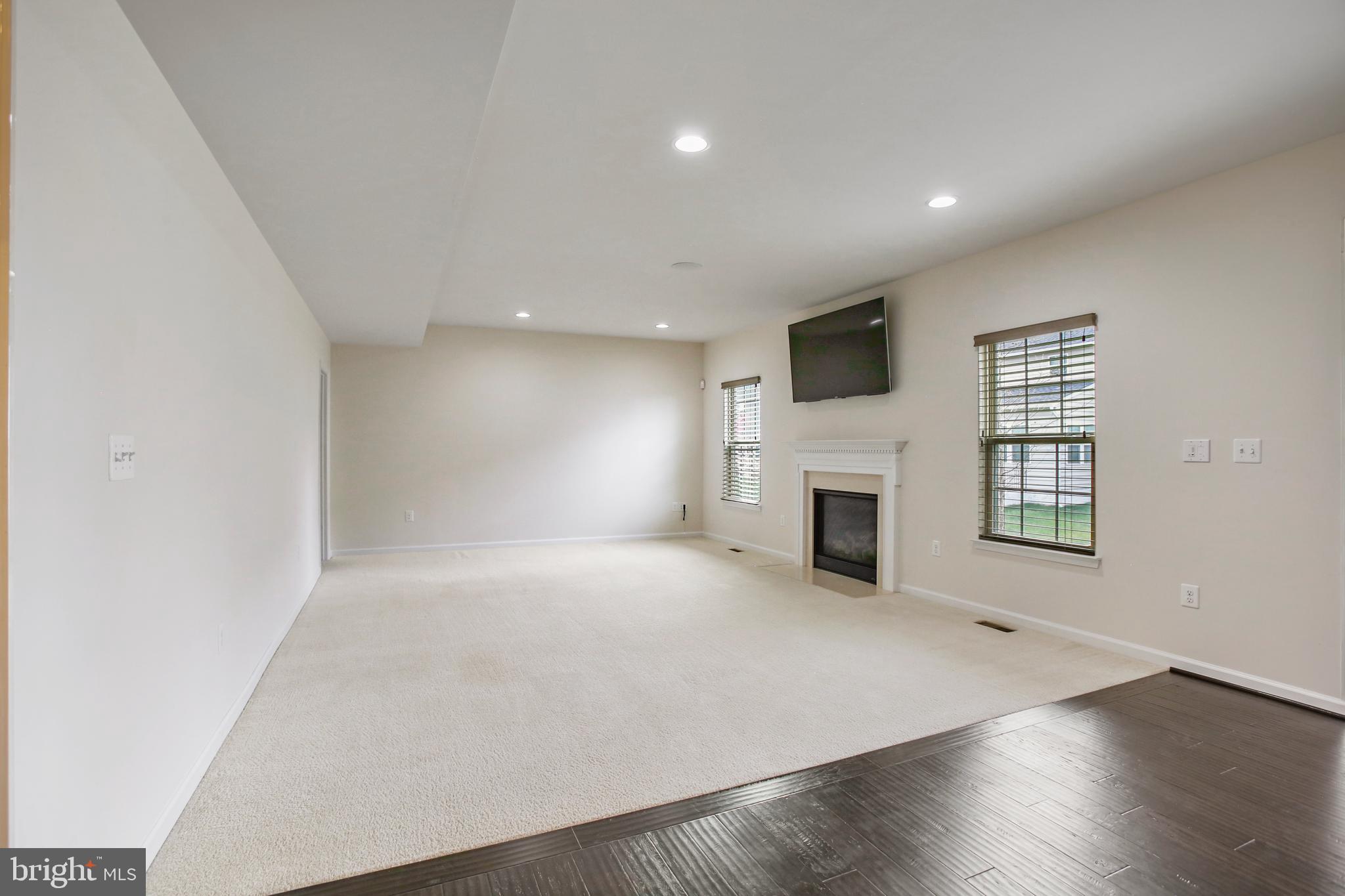 41597 Hoffman Drive Aldie, VA 20105 - Photo 13 of 42 an empty room with windows and fireplace