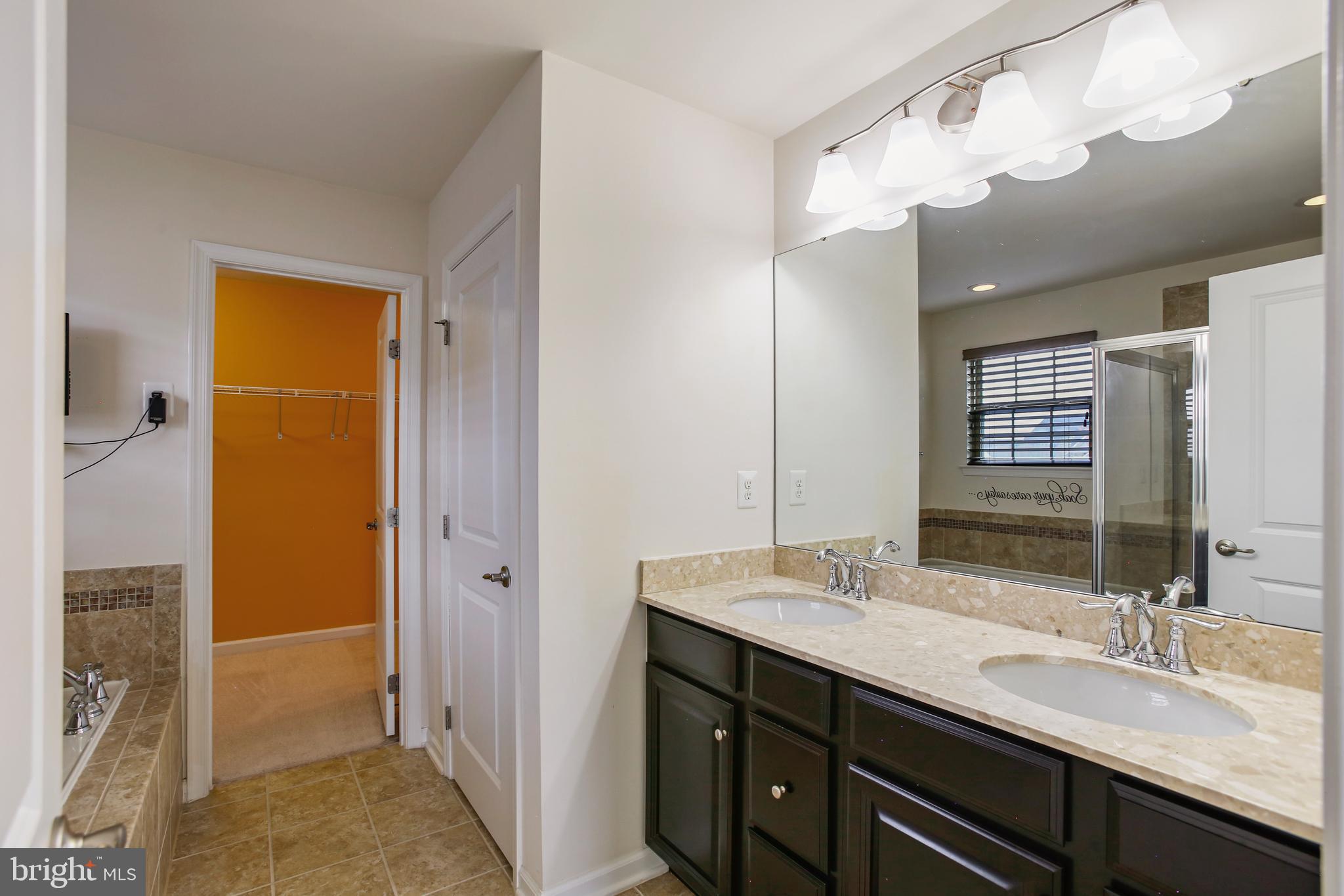 41597 Hoffman Drive Aldie, VA 20105 - Photo 24 of 42 a bathroom with a sink double vanity and a mirror