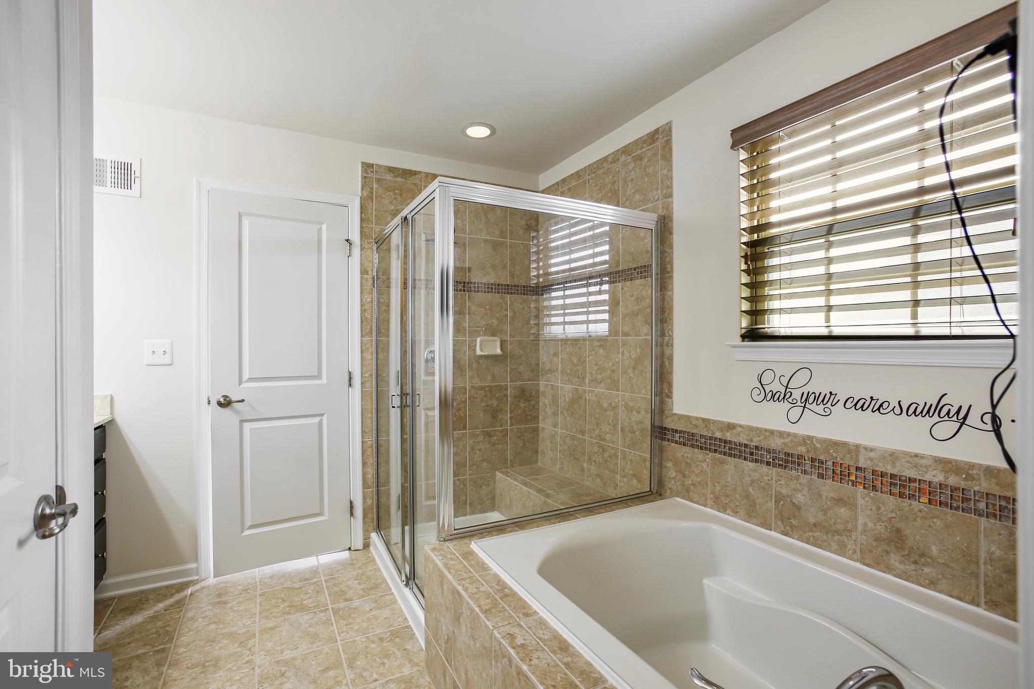 41597 Hoffman Drive Aldie, VA 20105 - Photo 25 of 42 a bathroom with a bathtub and shower