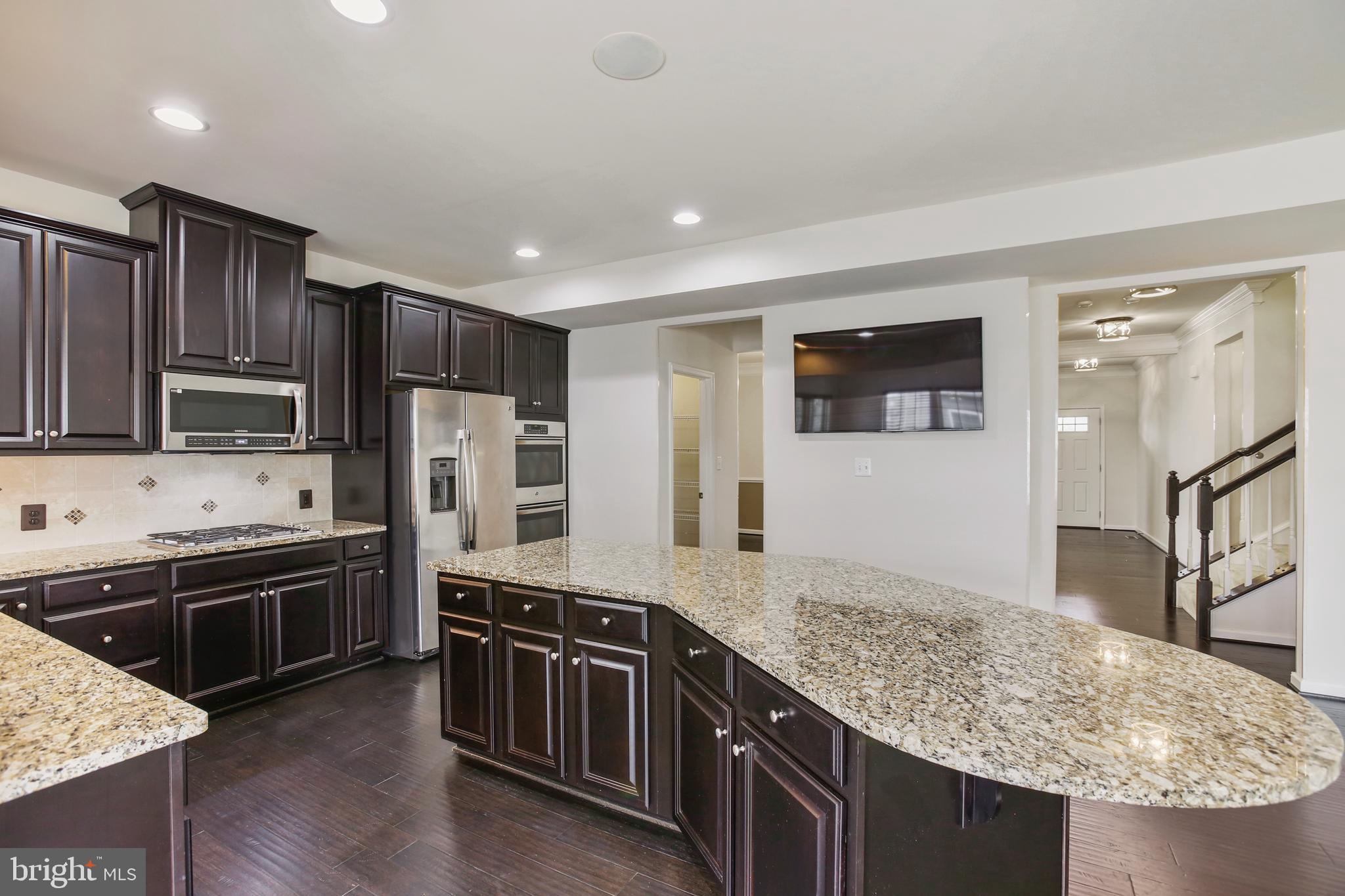 41597 Hoffman Drive Aldie, VA 20105 - Photo 9 of 42 a kitchen with stainless steel appliances granite countertop a sink stove and refrigerator