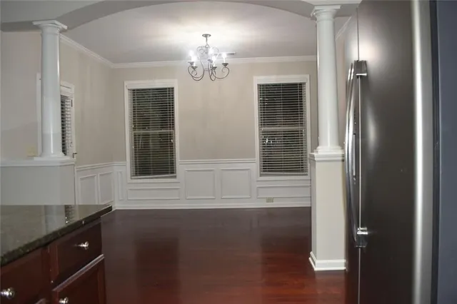 a view of a livingroom with wooden floor and a fireplace
