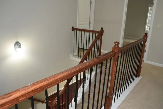 a view of staircase with railing and a window