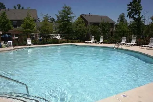 a front view of a house with a yard and potted plants